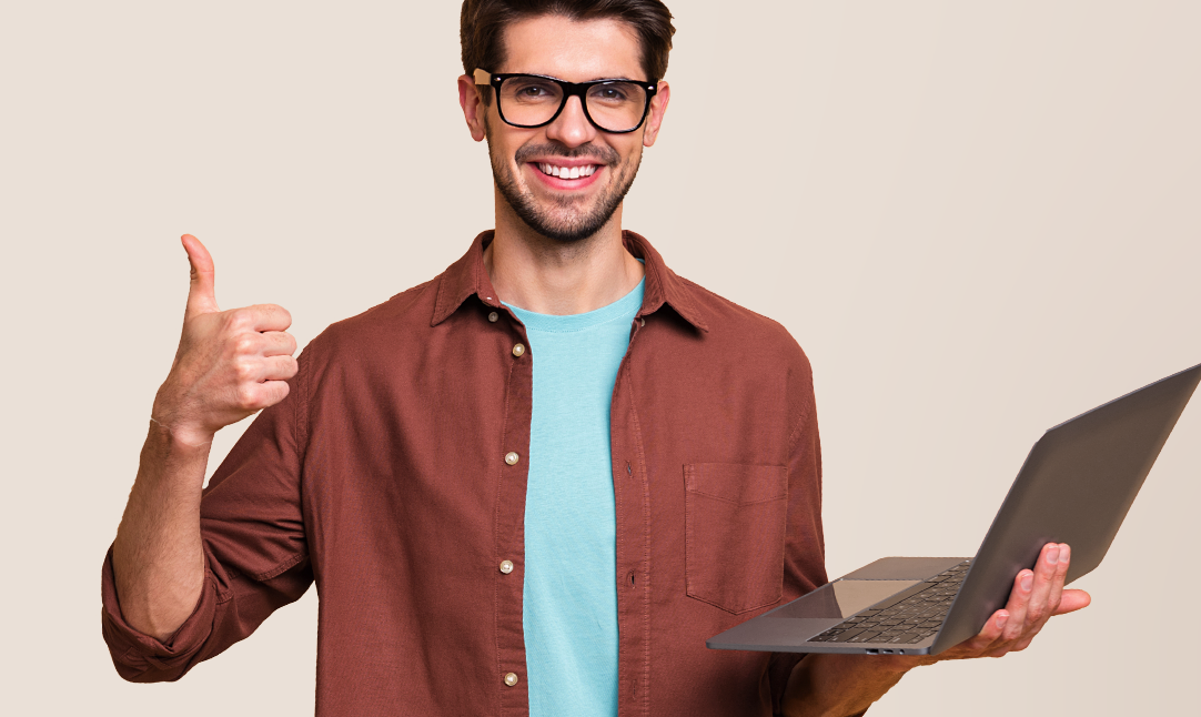 Happy man holding laptop